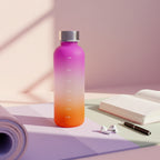 Gradient water bottle with pink to orange color scheme on a light surface.