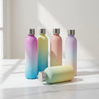 Set of gradient water bottles on a pink and purple background with a yoga mat and books.