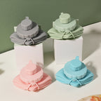 Silicone folding bottles in various colors with packaging on a light surface.