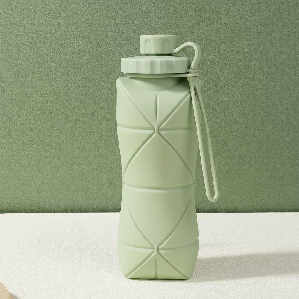 Green silicone folding bottle with packaging on a green background