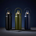 Green, Black and Navy Blue water bottle with a cap Dark moody studio background, deep navy blue gradient, black slate surface