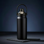 Dark blue water bottle with a black lid on a dark background