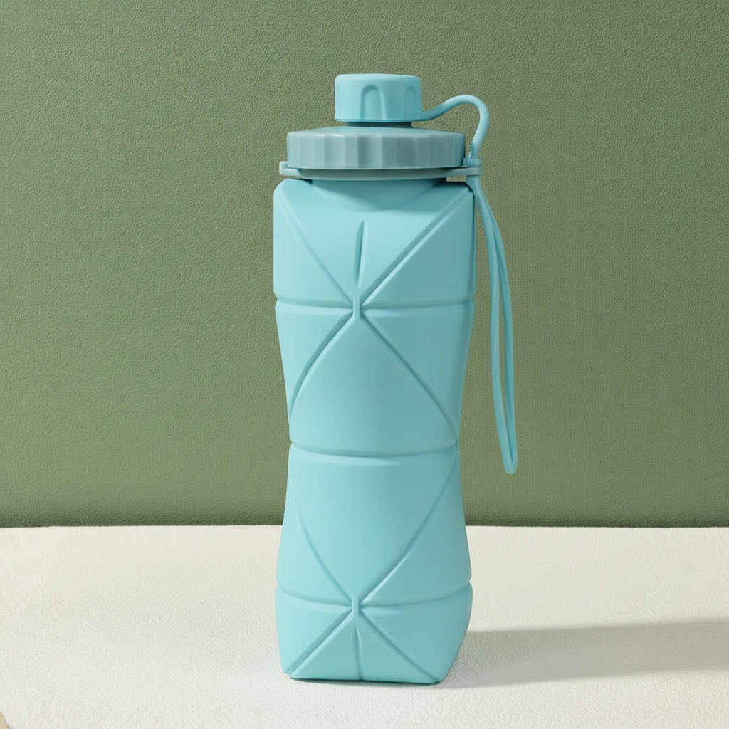 Blue silicone folding bottle with packaging on a light green background